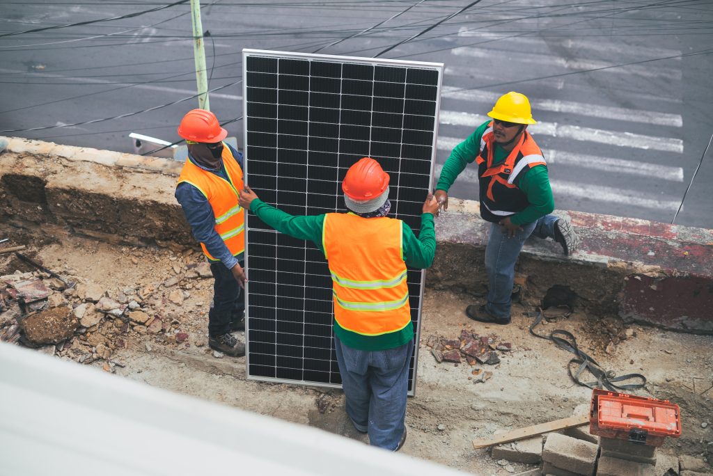 Field workers and solar panel
