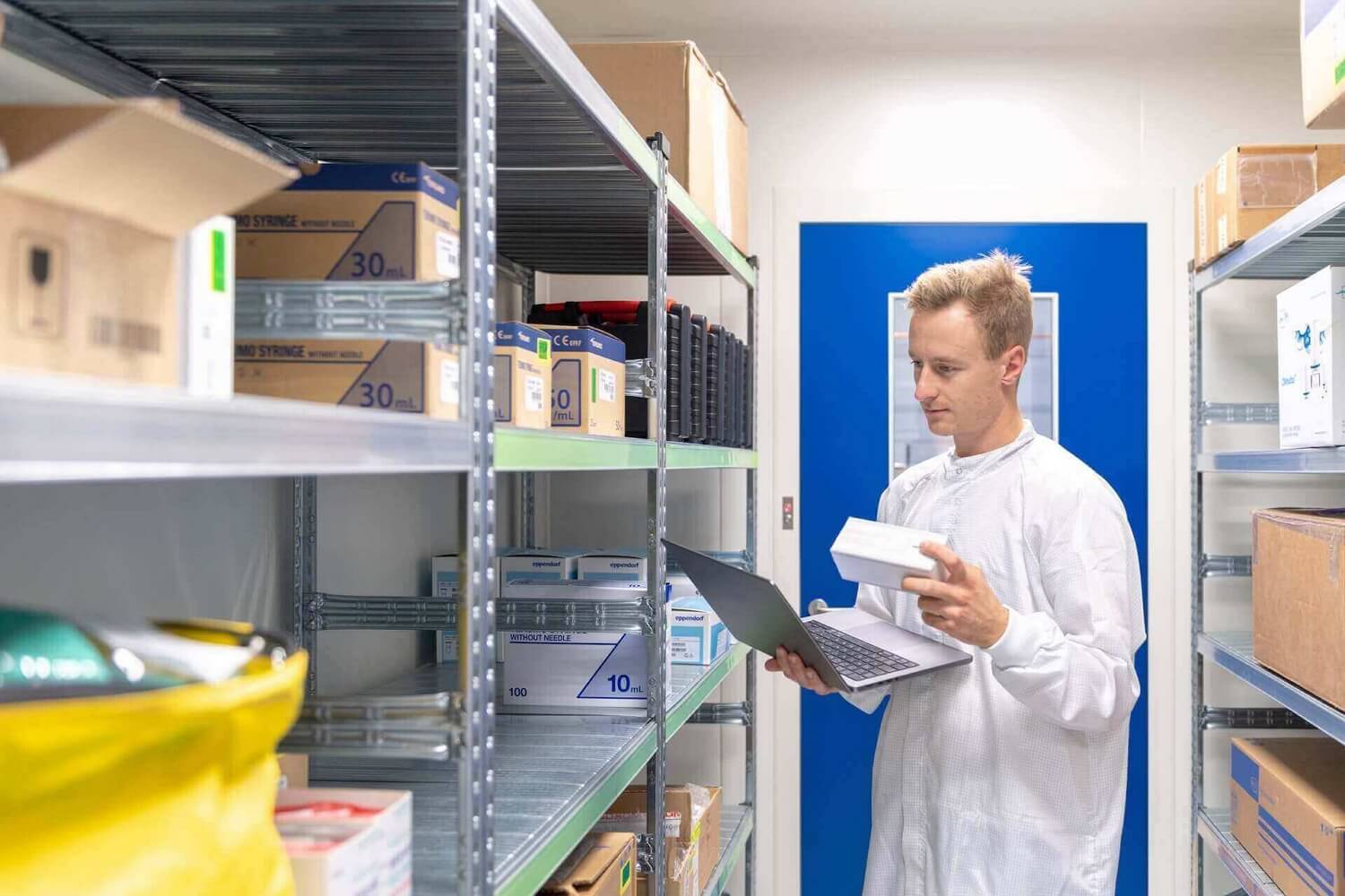 Man in white coat checking the inventory
