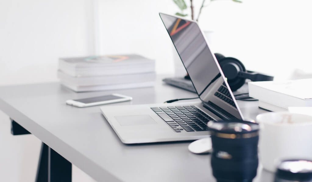 Laptop on a desk and mug