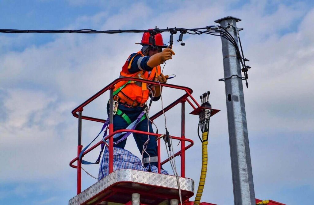 An electrician is repairing the power line