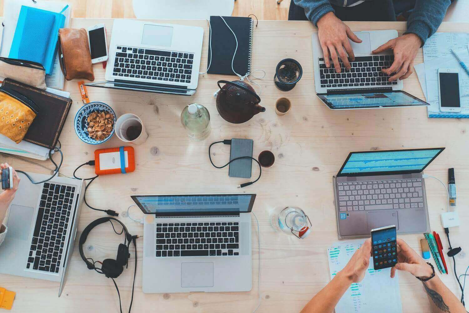 Working desk with mobile phones, laptops, coffe