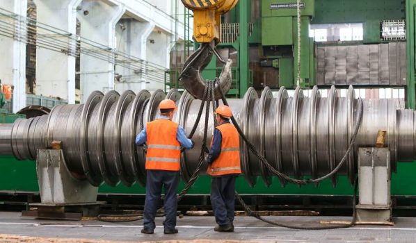 People Standing beside a Steel Machine