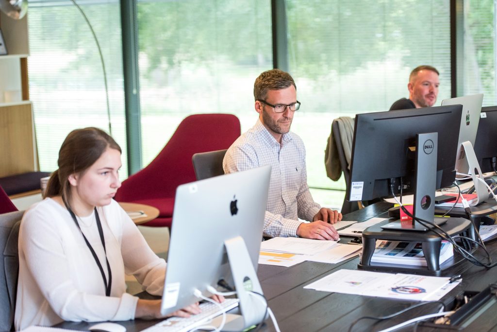 People sitting in an office and using CMS for Preventive Maintenance