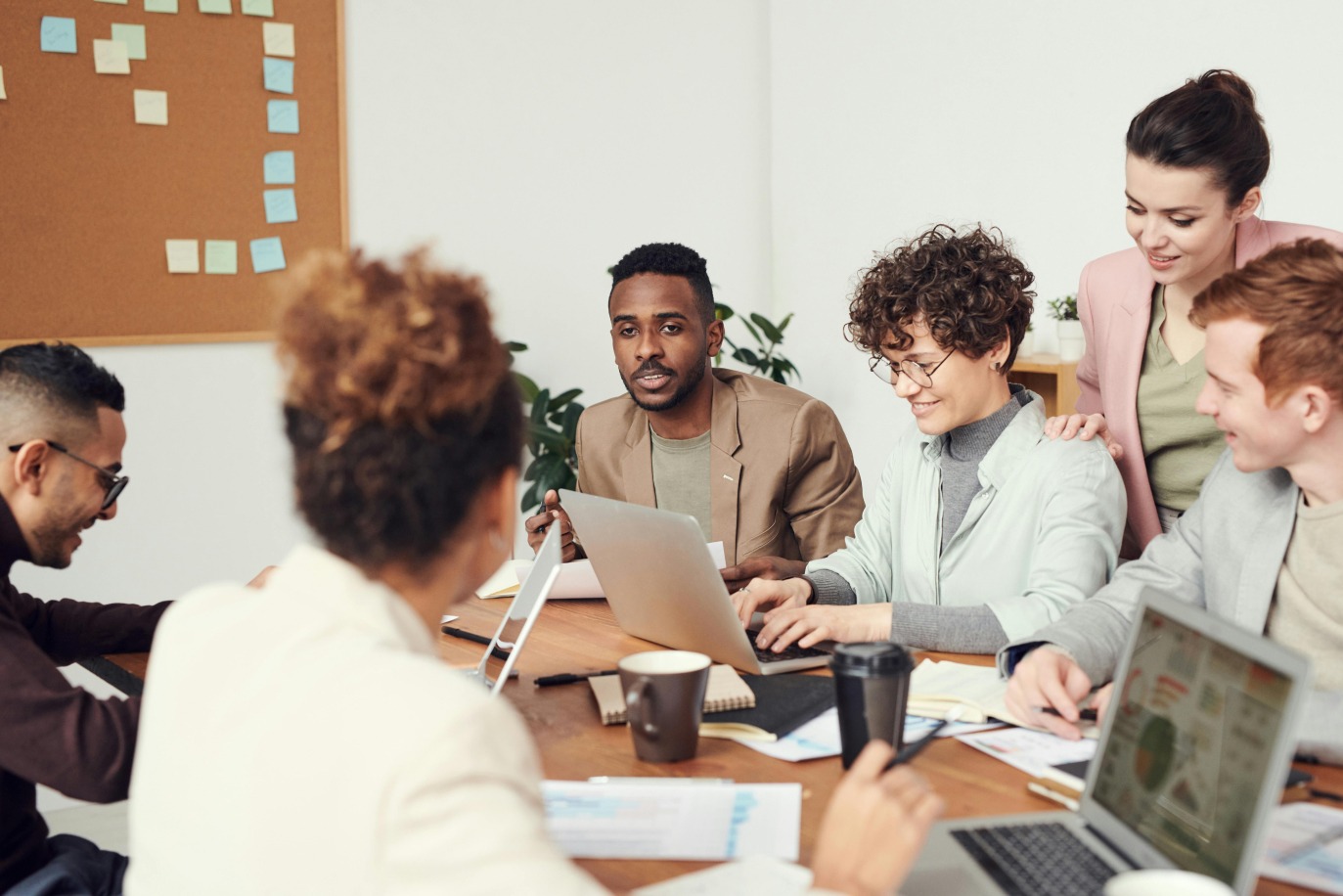 Employees in a business meeting included in implementing word order management software