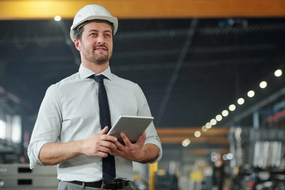 Man with a helmet holding a tablet