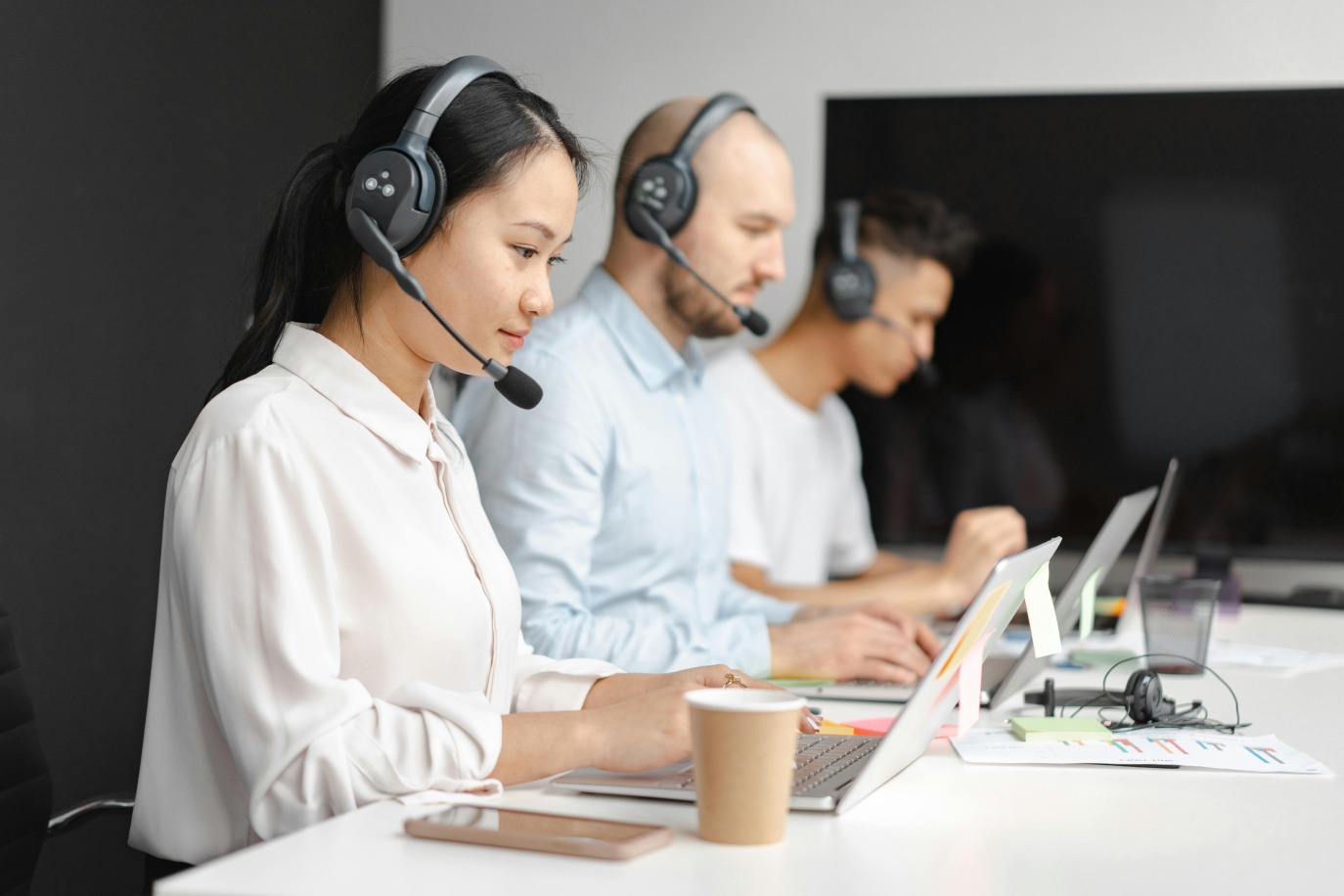 Three people working in a customer support for work order management software